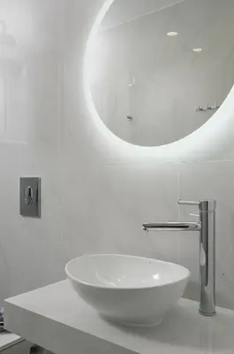 a bathroom with a white sink and a mirror at Kristall Suites in Stalos