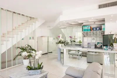 a living room with a staircase and a table at Kristall Suites in Stalos