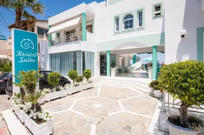 a white building with a sign in front of it at Kristall Suites in Stalos