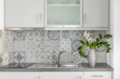 a kitchen with a sink and a vase of flowers at Kristall Suites in Stalos