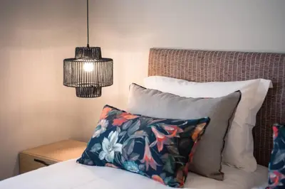 a bedroom with a bed with a pillow and a lamp at House 8 - In the Heart of Venetian town w. Parking in Chania Town