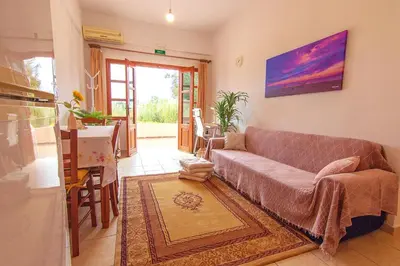 a living room with a couch and a table at Liviko Beach Apartments - only adults in Frangokastello
