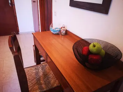 a bowl of fruit sitting on a wooden table at Orthi Ammos in Frangokastello