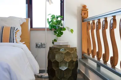 a bedroom with a bed and a vase with a plant at Villa Nikis in Chania Town