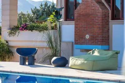 a swimming pool with a couch next to a house at Villa Nikis in Chania Town
