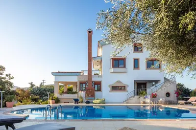 a house with a swimming pool in front of a house at Villa Nikis in Chania Town