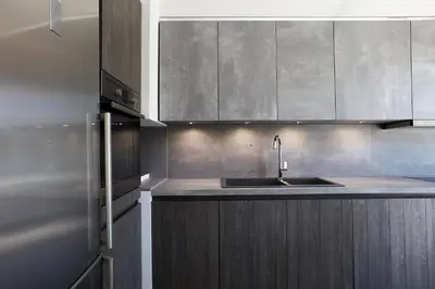 a kitchen with a sink and stainless steel cabinets at Chrissula apt Homeleader in Chania Town