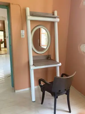 a mirror and a chair in a room at Sergios Village House in Chania Town