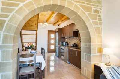 an archway in a kitchen with a table and chairs at Platania's Paradise in Chania Town
