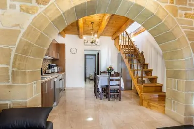 a kitchen and dining room with an archway in a house at Platania's Paradise in Chania Town