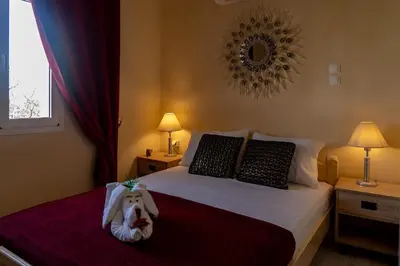 a bedroom with a bed with a stuffed animal on it at Chrispa's House in Chania Town