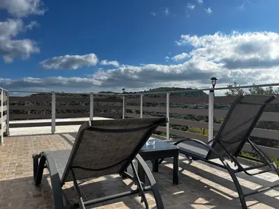 two chairs and a table on a patio at Chrispa's House in Chania Town