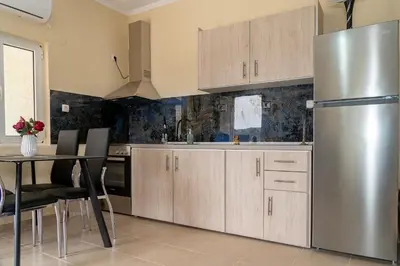 a kitchen with wooden cabinets and a stainless steel refrigerator at Chrispa's House in Chania Town