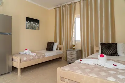 a bedroom with two beds and a window at Chrispa's House in Chania Town