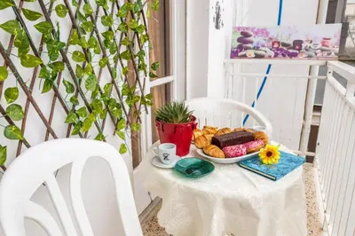 a table with a plate of breakfast food on a balcony at Katerina's Apartment in Chania Center in Chania Town