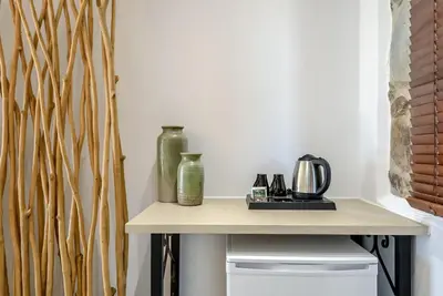 a table with two vases on top of it at Minos Country Living Apartments in Agrilés
