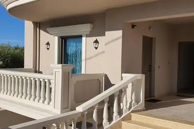 a house with a white staircase and a window at Olivia in Chania Town