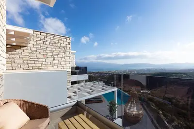 a balcony with a view of the mountains at Argyrie Villas, luxury, amazing sea view, heated pool in Kalleryianá