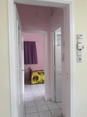 a hallway with pink walls and a room with a yellow object at Angel Villa in Strovlés