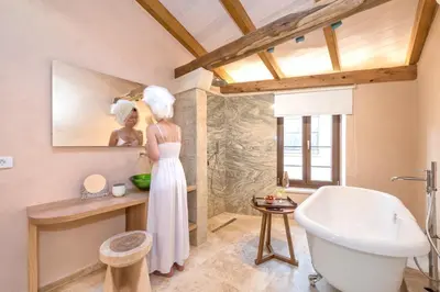 a woman in a white dress standing in a bathroom at Casa Livieres in Chania Town