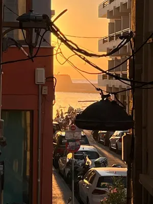 a street in a city with cars parked at Casa Livieres in Chania Town