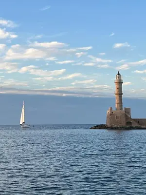 a sail boat in the water with a lighthouse at Casa Livieres in Chania Town