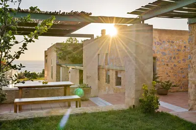 a patio with a table and a bench on a building at Villa Mediterranea - Heated Pool optional in Livadia