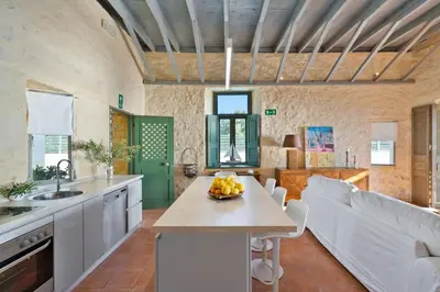 a kitchen with a table with a bowl of fruit on it at Villa Mediterranea - Heated Pool optional in Livadia