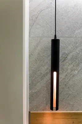 a black pendant light hanging from a wall at Just Creta Sea View apartment in Chania Town
