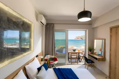 a hotel room with a bed and a view of the ocean at Just Creta Sea View apartment in Chania Town