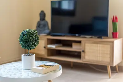 a living room with a table with a plant on it at Amphitrite Beach House in Chania Town
