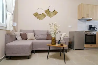 a living room with a couch and a table at RODOU Suites & Villas in Chania Town