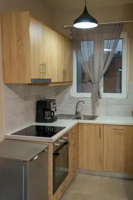 a kitchen with a stove and a sink and a window at RODOU Suites & Villas in Chania Town