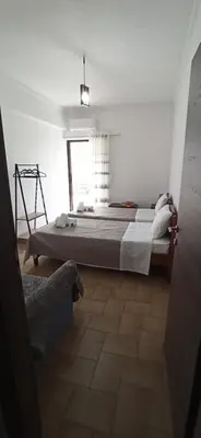 a bedroom with a large bed in a white room at GS Lumen Apartment in Chania Town