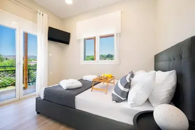 a bedroom with a bed and a balcony at MM Villa in Chania Town