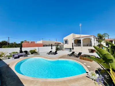 a swimming pool in front of a house at Villa Elena - Private Villa in the heart of nature in Chania Town