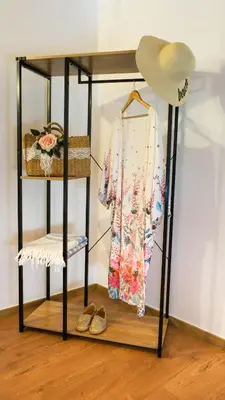 a shelf with a dress and a hat and shoes at VAMA APARTMENT in Plataniás
