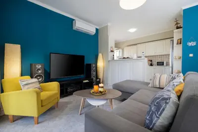a living room with a couch and a tv at Casa Regno in Ayiá