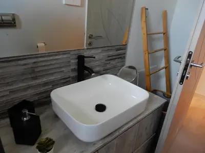 a white sink in a bathroom with a mirror at Royal Legend Suite in Souda