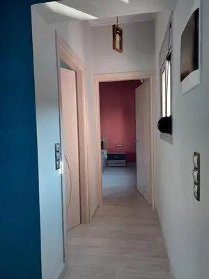 a hallway leading to a room with at Royal Legend Suite in Souda