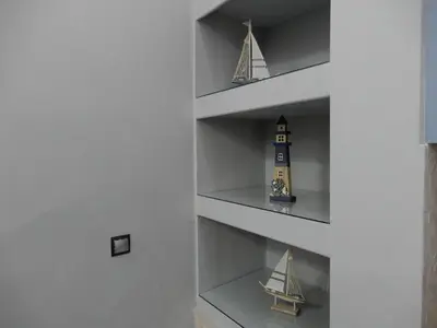 a shelf with a toy boat and a lighthouse at Royal Legend Suite in Souda