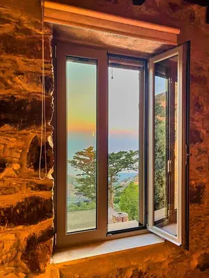a window with a view of the ocean at INO III Domus SWIMSPA by Amigdalokefali Elafonissi in AmigdhalokeFálion