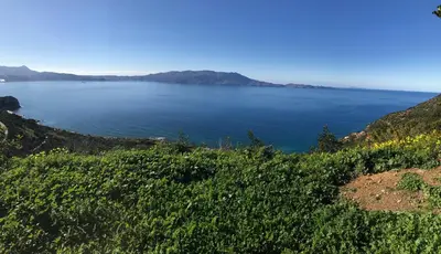 a view of the ocean from the side of a hill at Poseidon Apartments in Kissamos