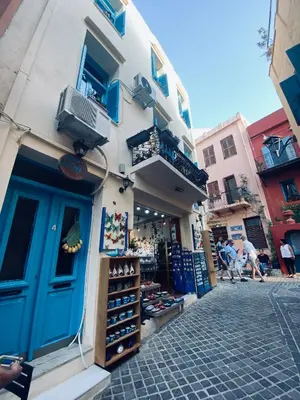 a building with a blue door on a street at DIONI in Chania Town