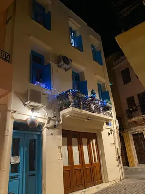 a building with a blue door and a balcony at DIONI in Chania Town