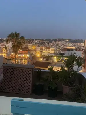 a view of a city at night from a balcony at DIONI 2 in Chania Town