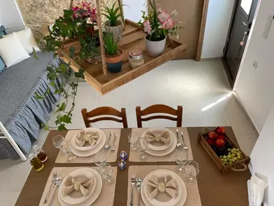 a table with plates of food and a bowl of fruit at Haroupia in Elafonisi