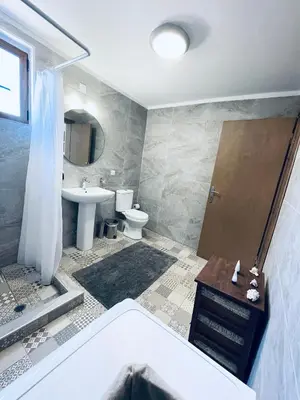 a bathroom with a tub and a toilet and a sink at Haroupia in Elafonisi