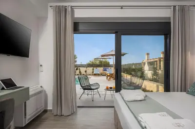 a bedroom with a bed and a view of a patio at Belair villas in Chania Town