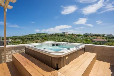 a hot tub sitting on top of a balcony at Belair villas in Chania Town